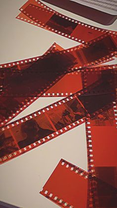 film strips laid out on top of a table with red and white squares around them