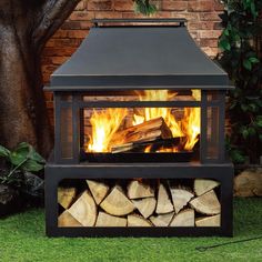 an outdoor fireplace with logs in the foreground