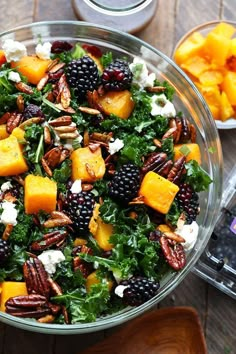 a glass bowl filled with salad and fruit