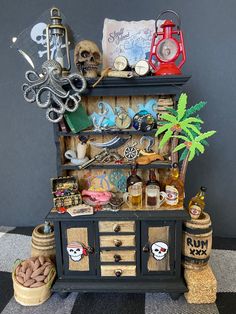 an old dresser with lots of items on top of it and some palm trees in the background