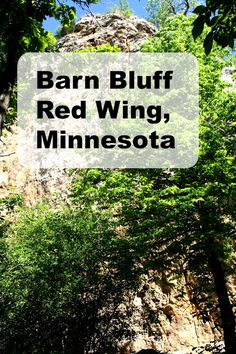 the words barn bluff red wing, minnesota are in front of trees and rocks on a sunny day