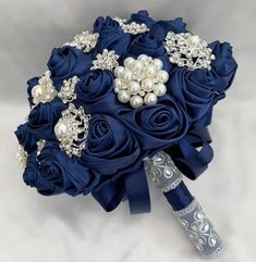 a bridal bouquet with blue roses and pearls