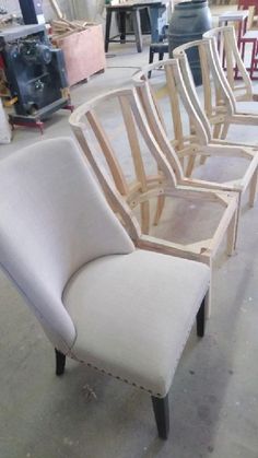 a row of chairs sitting on top of a floor next to each other in a room