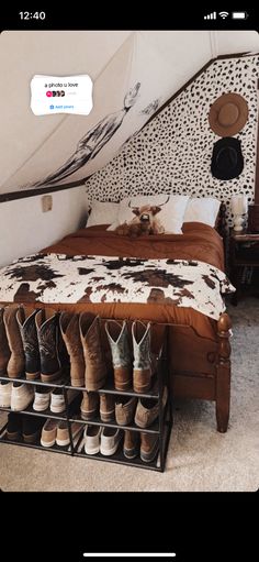 a bed with several pairs of shoes on it in a room next to a wall