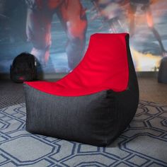 a bean bag chair sitting on top of a rug in front of a large wall