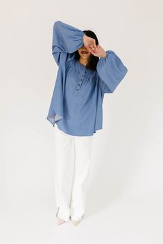 this retro-inspired long sleeve top will take you from summer picnics to fall photoshoots with ease. made with a dark wash denim-esque material, this elevated top features long balloon sleeves + a flowy silhouette. dress it up with trousers + heels, or down with white jeans + sandals. medium wash // high neckline, buttons, balloon sleeves, elastic cuffs paired with our camelot wide leg denim model is 5'8" + wearing a small measurements are approximate + taken while laying flat small : bust 42” l Fall Denim Puff Sleeve Top, Casual Tops With Bishop Sleeves For Summer, Medium Wash Long Sleeve Denim Top For Day Out, Casual Bishop Sleeve Tops For Summer, Spring Bishop Sleeve Blouse In Relaxed Fit, Spring Long Sleeve Peasant Top With Elastic Sleeves, Spring Bishop Sleeve Blouse With Relaxed Fit, Oversized Blouse With Gathered Sleeves For Spring, Chic Long Sleeve Denim Top For Summer