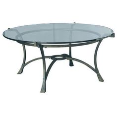 a glass table with metal legs and a round glass top on an isolated white background