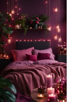 a bed with purple sheets and pillows in front of some plants, candles and potted plants