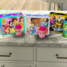 there are many princess lunch boxes on the counter