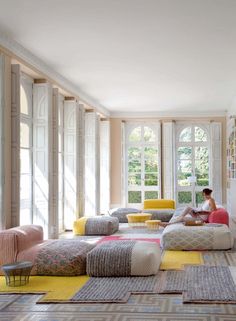 a woman sitting on top of a couch in a living room