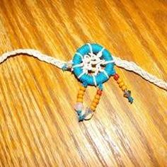 a small blue and white beaded object on a wooden table