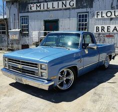 a blue truck parked in front of a building