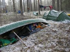 several tents in the woods with snow on them