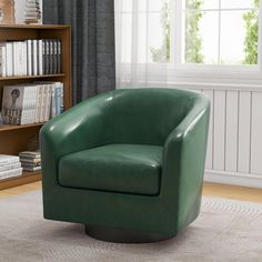 a green leather chair sitting in front of a book shelf next to a bookshelf