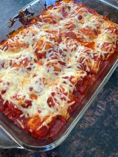 a casserole dish with meat and cheese on it sitting on a counter top