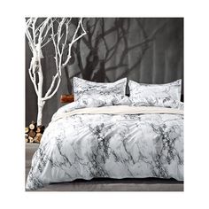 a white bed with black and grey marble print