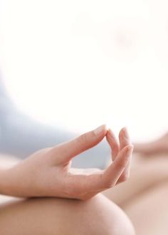 a woman is sitting in the lotus position