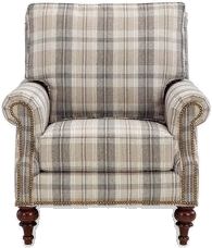 an upholstered plaid chair with wood legs and nail polishing on the armrests