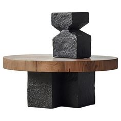 a wooden table topped with black rocks on top of it's sides and bottom