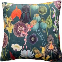 a blue pillow with colorful flowers and plants on the front, along with an orange flower