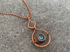 The evil eye spinner pendant necklace features a wire wrapped glass evil eye bead mounted inside a hematite stone, hung from a high-quality pure copper ball chain. This necklace is a beautiful accessory and a talisman to ward off negative energy. Wear alone or layer with other necklaces for a stacked look that's trending now. Perfect for everyday wear or as a thoughtful gift, the Evil Eye Bracelet adds a touch of mystique and protection to any style. Give as a memorable unique gift to the favorite woman in your life:  For Mother's Day, anniversary presents, Christmas gifts, birthday gifts, graduation and bachelorette parties. ## Sizing Total length around is 23 inches. Pendant drop length is 2 inches. For sizing help, see the sizing guide in the photos. ## Materials Every item is 100% hand Anniversary Presents, Glass Evil Eye, Presents Christmas, Mystical Jewelry, Stacked Necklaces, Bad Vibes, Hematite Stone, Fringe Necklace, Blue Evil Eye