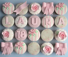 cupcakes decorated with pink and white frosting are arranged in the shape of letters