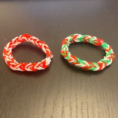 two different colored bracelets sitting on top of a table