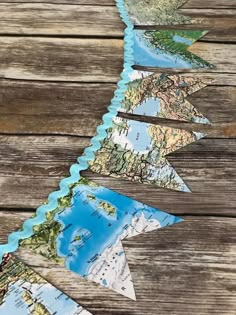 a wooden table topped with lots of paper cut out to look like the world map