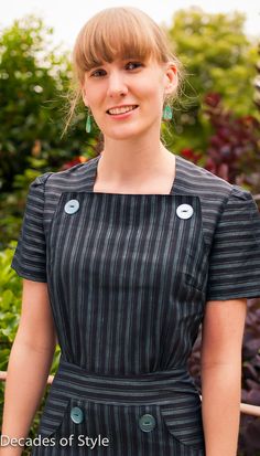 a woman with blonde hair wearing a black and white striped dress smiling at the camera