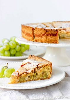 two plates with slices of cake on them and grapes in the background text reads roasted grape cake