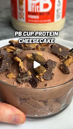 a person is holding a bowl of chocolate ice cream with peanut butter in the background