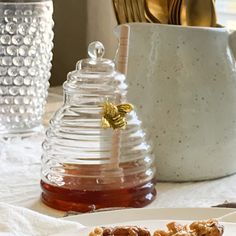 a plate with some cookies on it and honey in the background