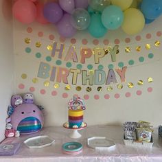 a birthday party with balloons, cake and confetti