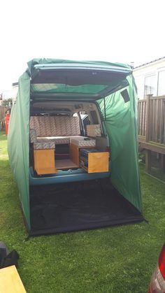 the back end of a van with its doors open and drawers in it's trunk