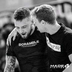 two men in black and white hugging each other with the words scramble on their chest