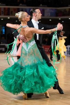 a man and woman dancing on a dance floor