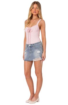 An on-trend low-rise cut defines this nonstretch-denim skirt featuring allover distressing for a chic lived-in look. Zip fly with button closure Five-pocket style 100% cotton Machine wash, dry flat Imported Ripped High Waist Fitted Mini Skirt, Ripped High-waist Fitted Mini Skirt, Fitted Ripped Mini Bottoms, Ripped Fitted High Waist Mini Skirt, High Waist Ripped Fitted Mini Skirt, Fitted Ripped Bottoms In Mini Length, Trendy Fitted Ripped Denim Skirt, Ripped Fitted Denim Mini Skirt, Fitted Distressed Medium Wash Mini Skirt