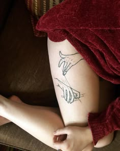 a woman's arm and hand tattoo on her leg