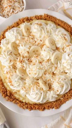 a white plate topped with a banana cream pie