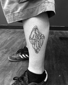 a man's leg with a geometric tattoo design on the lower half of his leg