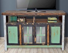 an old tv stand with some books on it