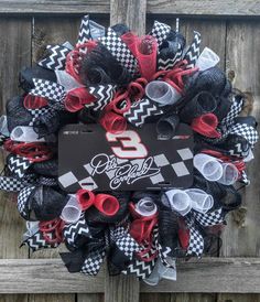 a wreath with the number 8 on it and red, white and black mesh flowers