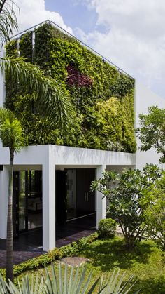 a house with plants growing on the side of it