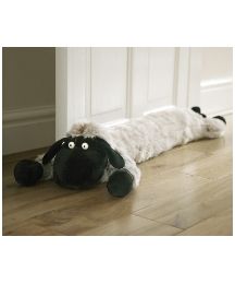 a stuffed animal laying on top of a wooden floor next to a white door way