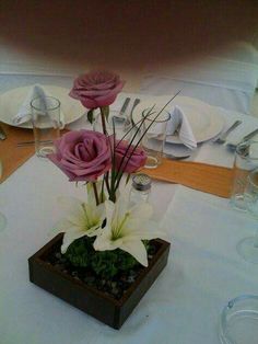 there is a vase with flowers in it on top of the table at this wedding reception