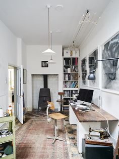 a room with a desk, chair and bookshelf