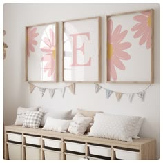 three framed pictures hang on the wall above a bench with pillows and baskets underneath them