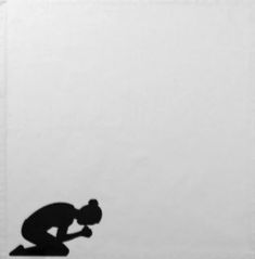 a silhouette of a person kneeling down on the ground