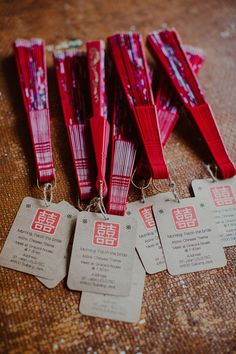 five red packets with tags attached to them sitting on a table next to each other