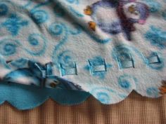 the fabric is blue and white with flowers on it, along with an applique